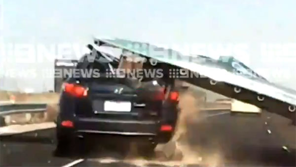 highway accident video sign board falls on car